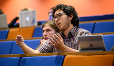a student gesturing in a lecture